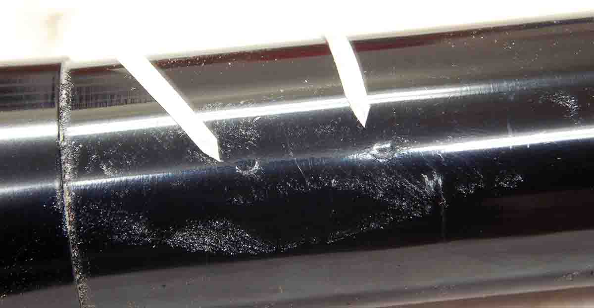 This shows small dents and scratches on the scope tube from poorly-fitting import rings. The damage is small because the scope was on a rimfire rifle having no recoil.